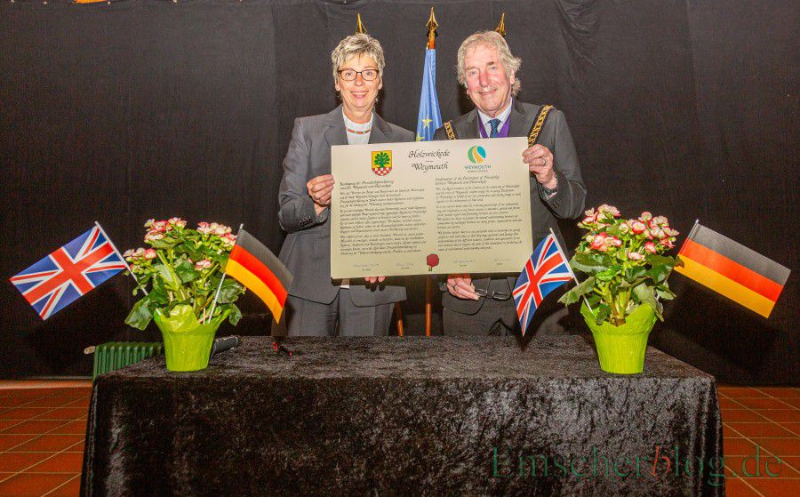 Bürgermeisterin Ulrike Drossel und der Councillor Graham Winter zeigen die unterschriebene Urkunde, mit der Holzwickede und Weymouth heute ihre Freundschaft erneuert haben. (Foto: P. Gräber - Emscherblog.de)